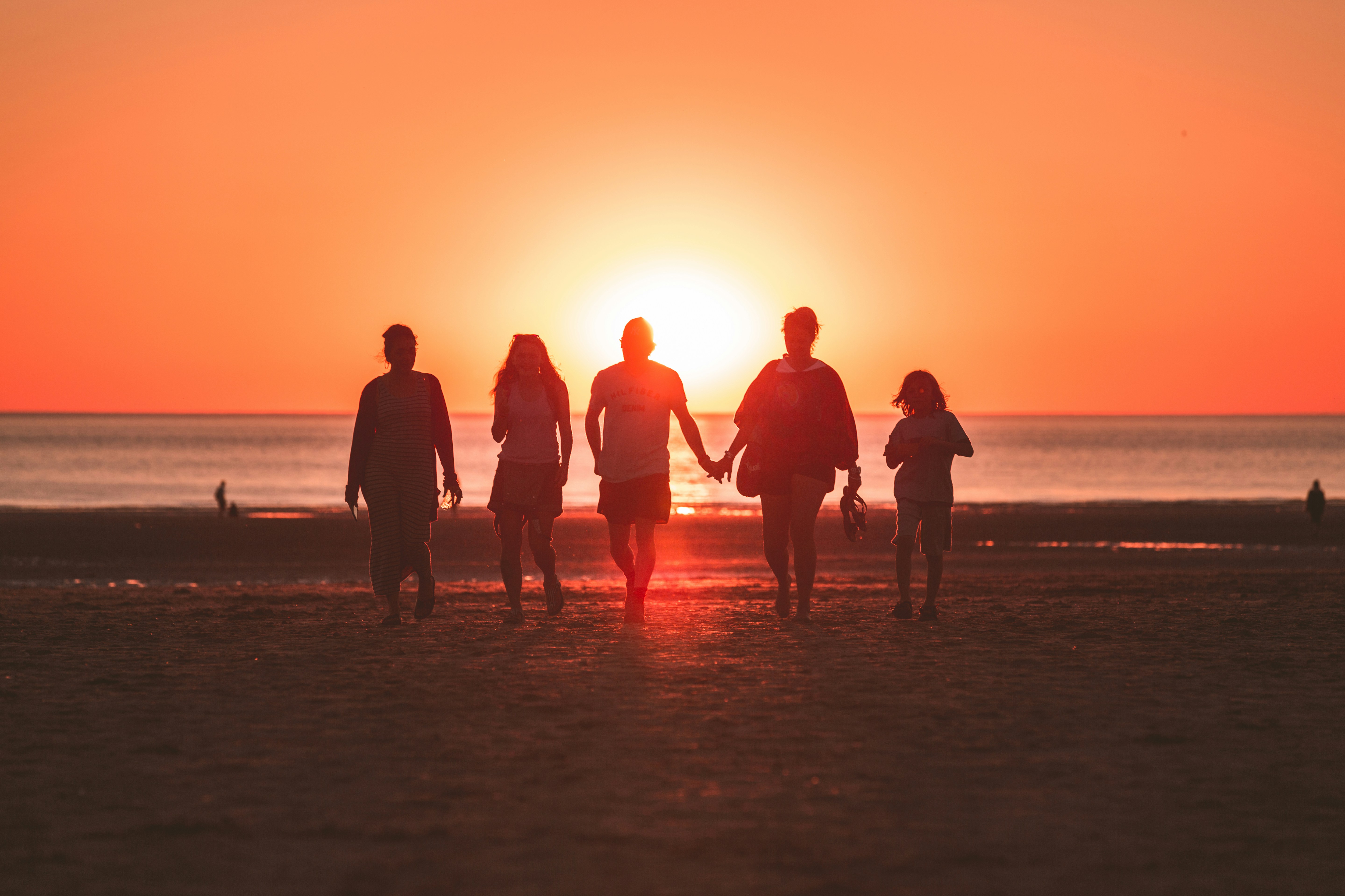 I was randomly shooting the sunset when a family decided to walk back from the sea to the beach, I was just perfectly aligned with them and the golden hour sun. Captured the cute moment where the mother and father were holding hands. They noticed me afterwards and they asked if I had an instagram so they could see my work. We had a little chat and I showed the fresh photo directly on my camera screen, they were really happy with it !
I love the tones and how the backlight enhances group.